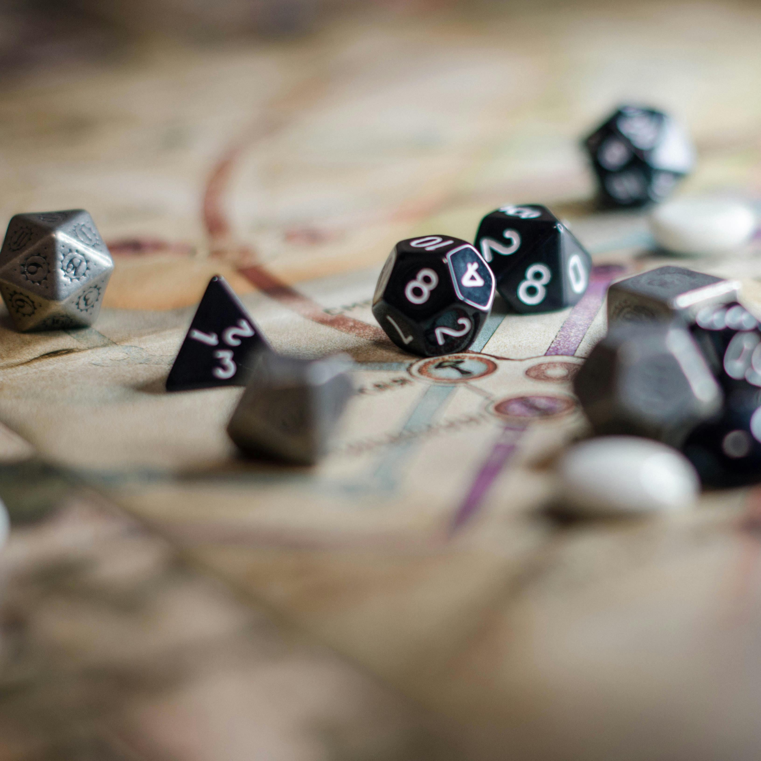 Dice on a table, with map adventure awaits dungeons an dragon
